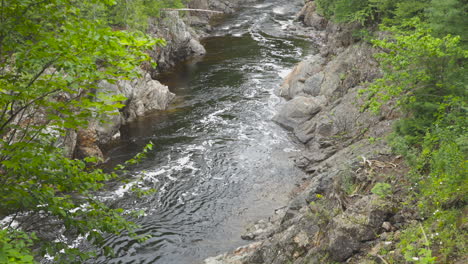 the batchawana river flows out from some falls toward lake superior through the remote forests of ontario