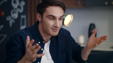 excited businessman celebrating success on video call at remote workplace.