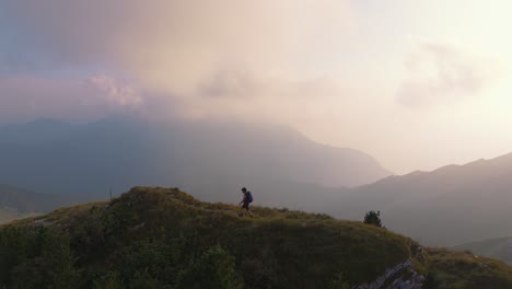 young man hiking in scenic italian alps mountains on panoramic monte baldo near lake garda, verona
