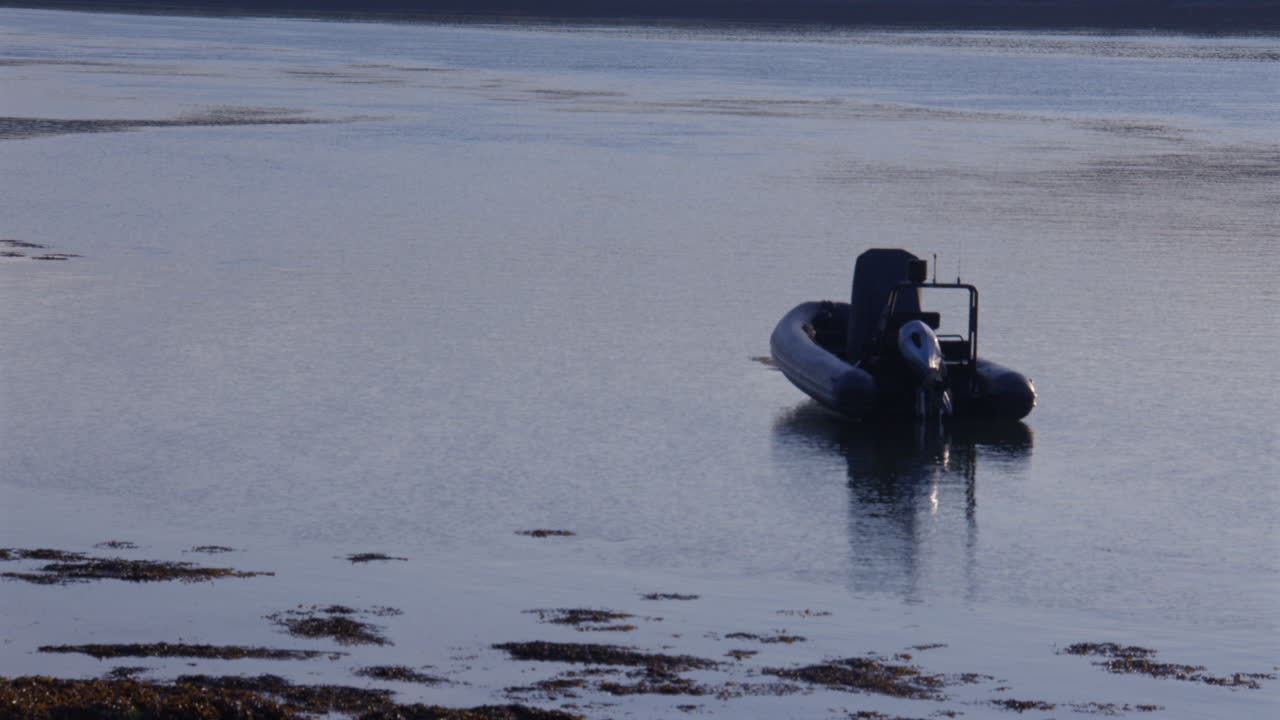 shot looking up the Menal Strait with rib boat in the early morning low tide at Moel Y Don, Llanfairpwllgwyngyll