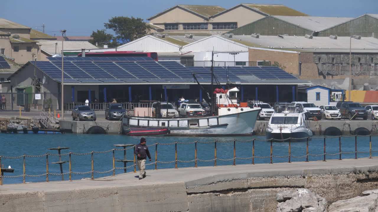 A fishing boat docked at Lambert's Bay harbour in South Africa on a clear sunny day
