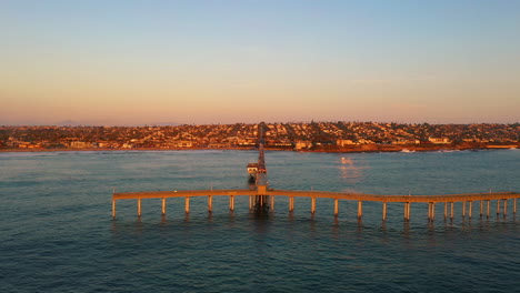 Ocean-Beach-Pier-in-San-Diego,-pylons-reflection-in-ocean