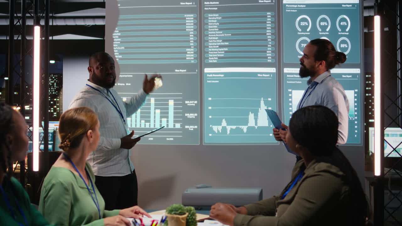 Multiethnic staff members examining data insights to evaluate business activity
