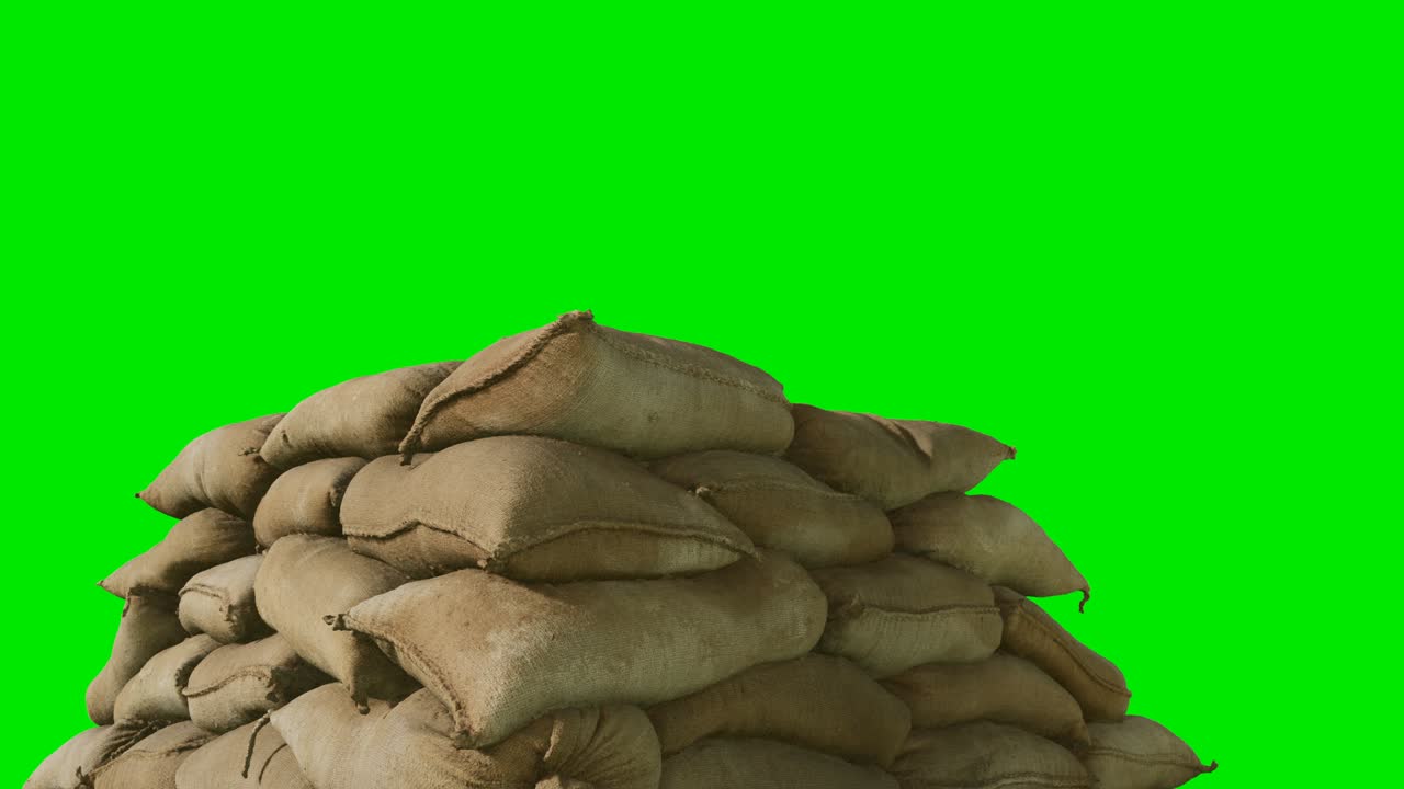 bolsas de arena para defensa contra inundaciones o uso militar sobre fondo de color verde
