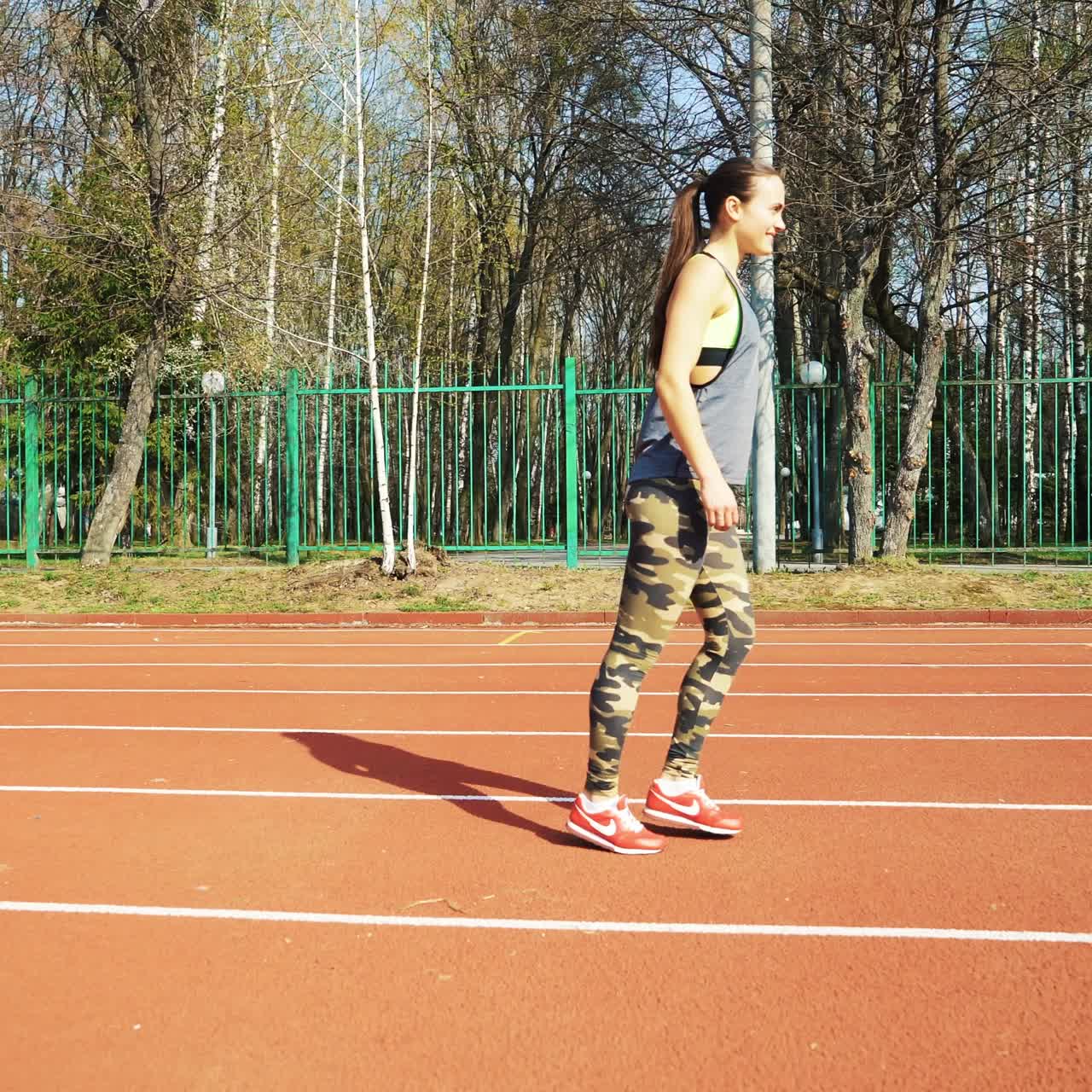 Athletic woman running on track. Healthy fitness lifestyle.
