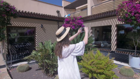 woman taking a picture in a garden