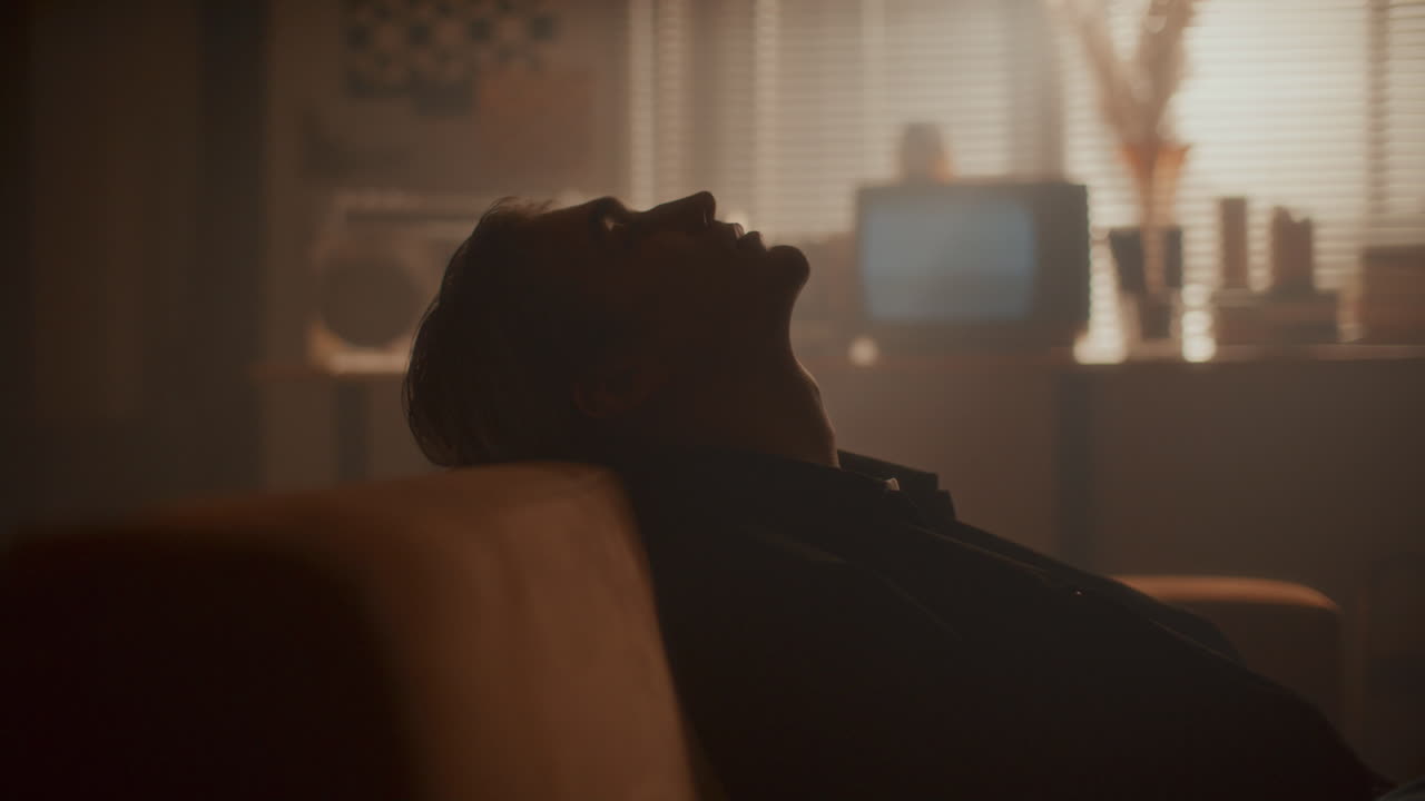 Pensive Man Relaxing on Couch in Living Room with Vintage Decor