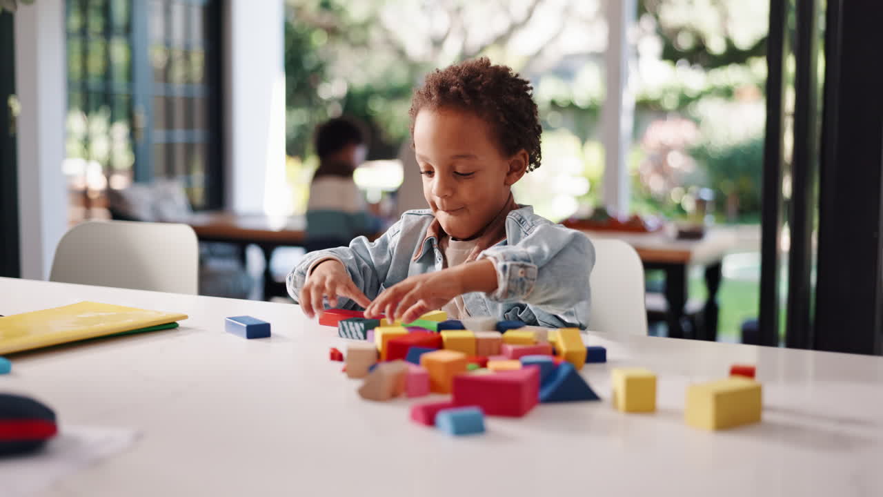 Boy playing with building blocks at home