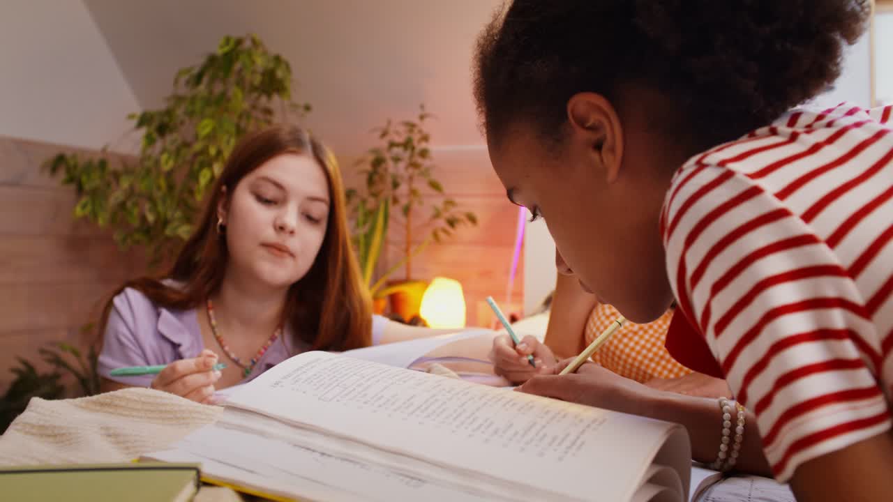 Teenage girls studying together
