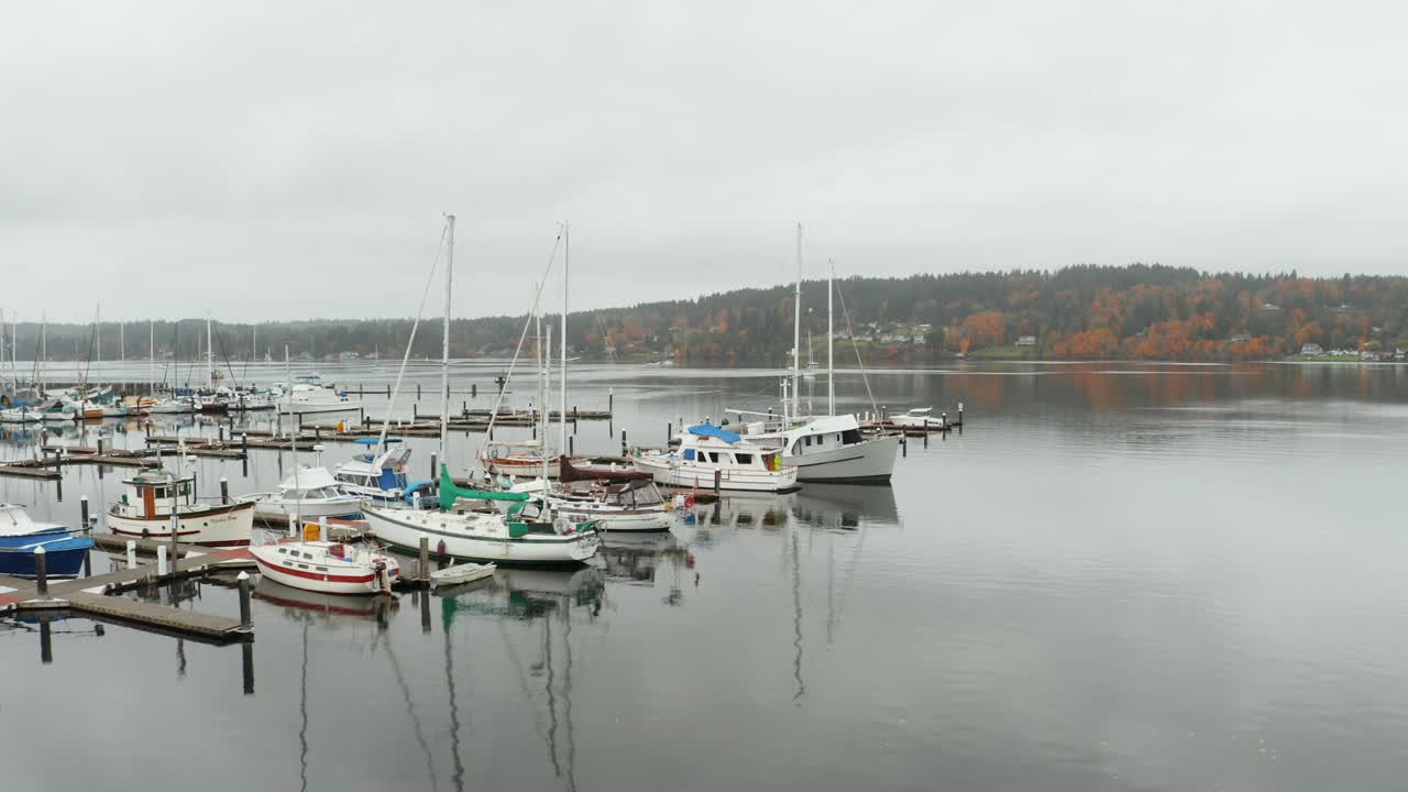 Boats in the marina of calm lake on a cloudy day in Washington, USA