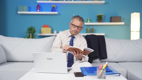home office worker man reading a book.