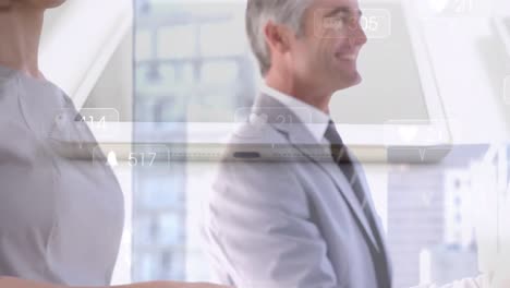 digital icons with increasing icons over mid section of businessman and businesswoman shaking hands