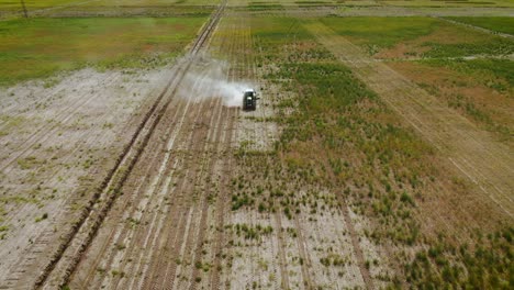 farmland with tractor mowing weeds in almaty, kazakhstan - aerial drone shot