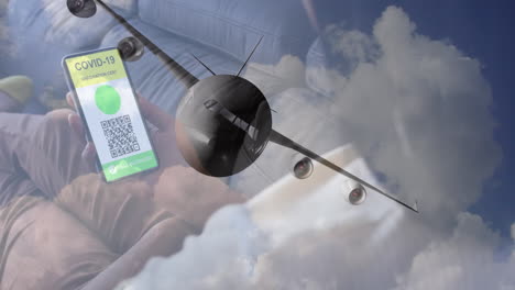 woman holding a smartphone with qr code on screen against airplane flying in the sky