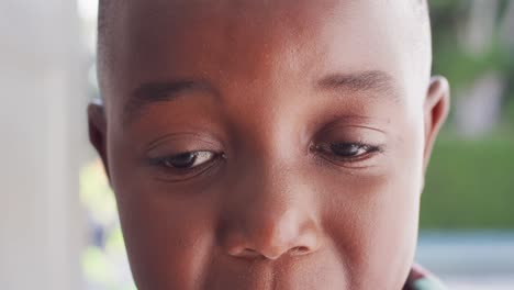 portrait of happy african american boy at door