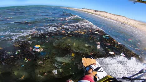 freestyle kitesurfing on son hai,vietnam coast contaminated by plastic rubbish