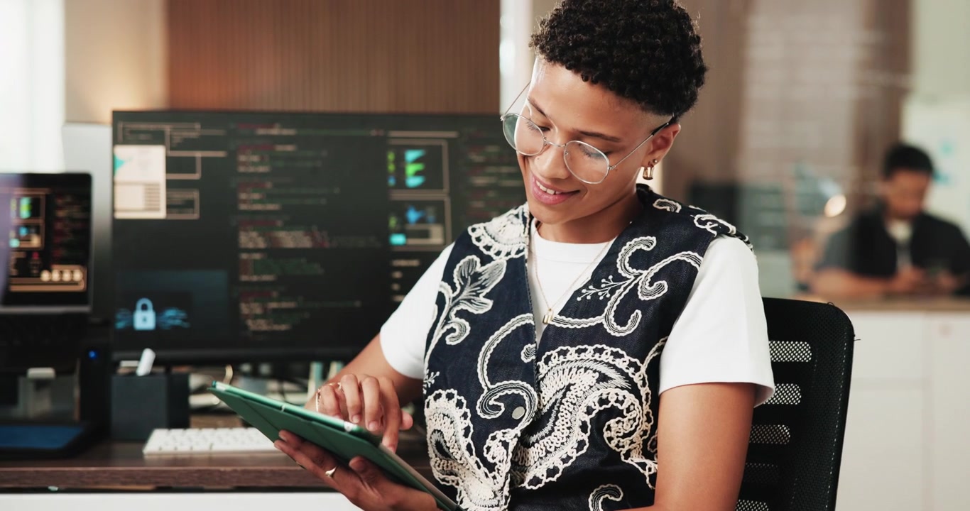 Young Software Developer Using Tablet in Modern Office