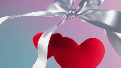 red hearts and white ribbons on a gradient background