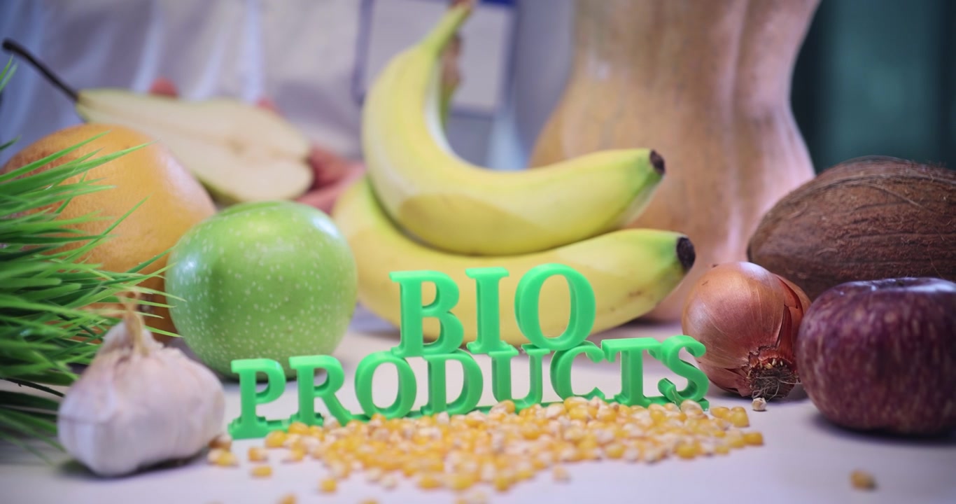 Bio products text with fresh fruits and vegetables on doctor desk