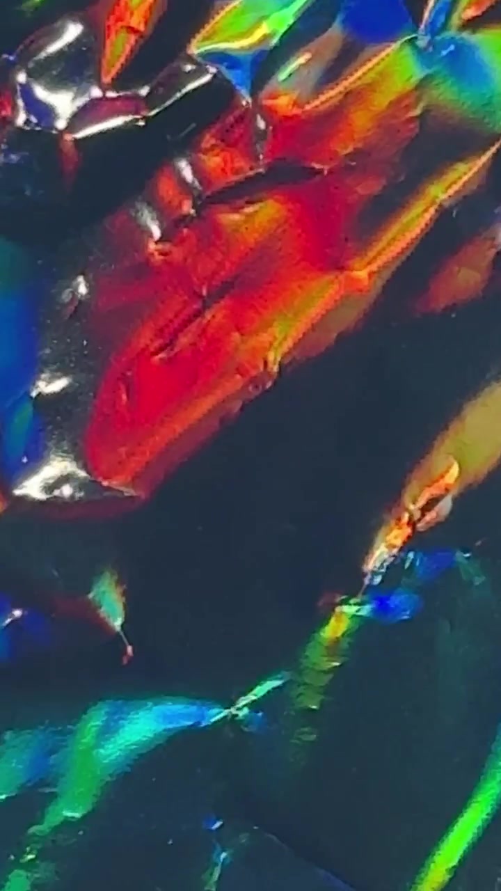 Abstract Iridescent Holographic Foil Texture Moving in Light