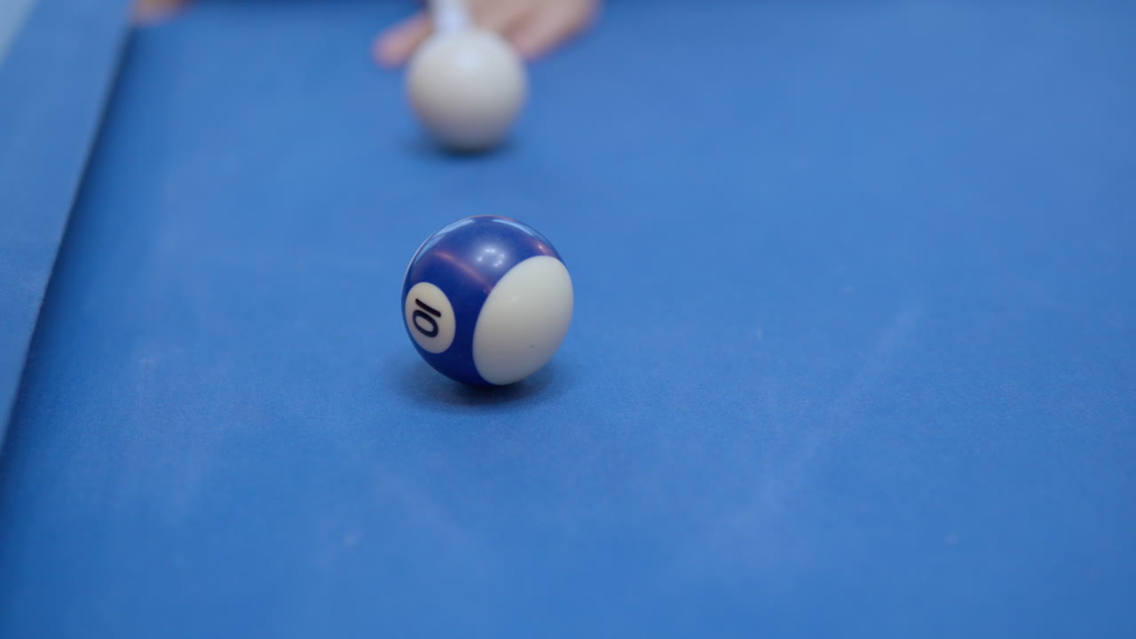 Pool, Pocket Billiards - Cue Ball Hitting One Ball in Focus in Slow motion - closeup