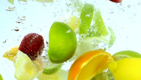 fruit dropped into water in slow motion