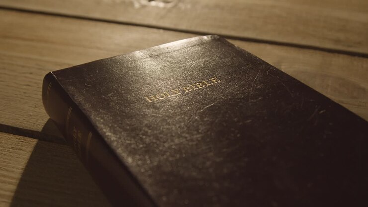 Religious Concept Shot Of Old Bible On Wooden Table