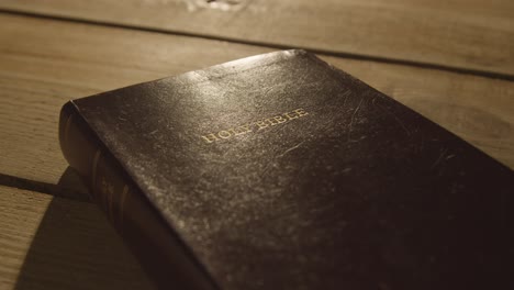 religious concept shot of old bible on wooden table