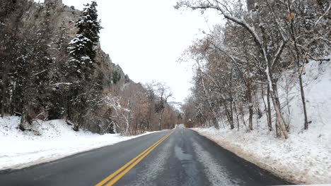 driving pov of snowy mountain roads in american fork canyon, utah