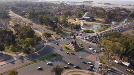 Aerial-view-of-Monumento-a-Urquiza-with-driving-cars-and-Planetarium-in-background---Buenos-Aires,Argentina