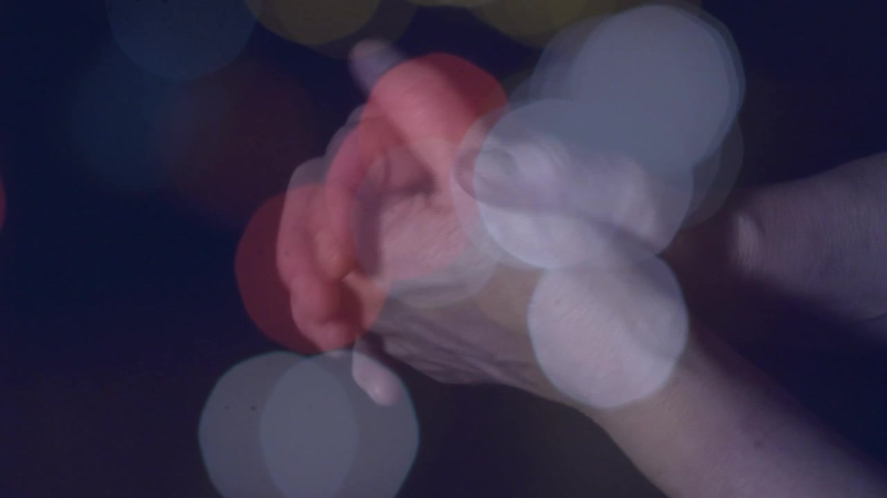 Hands starting together, interlacing fingers and rotating thumbs, forming gentle clasp for calm