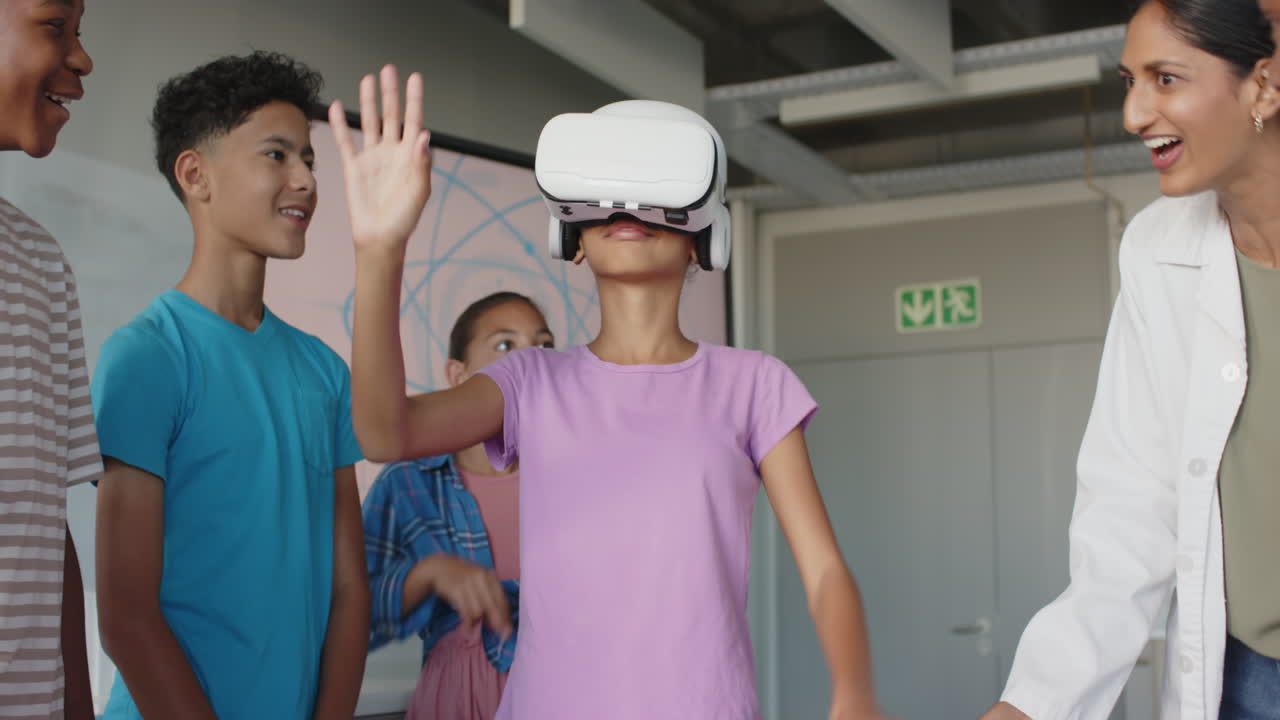 In school, girl using VR headset while classmates and teacher watching and smiling
