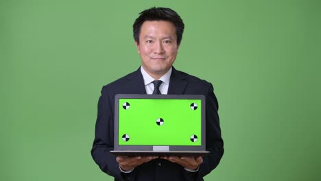녹색 배경에 성숙한 일본 사업가