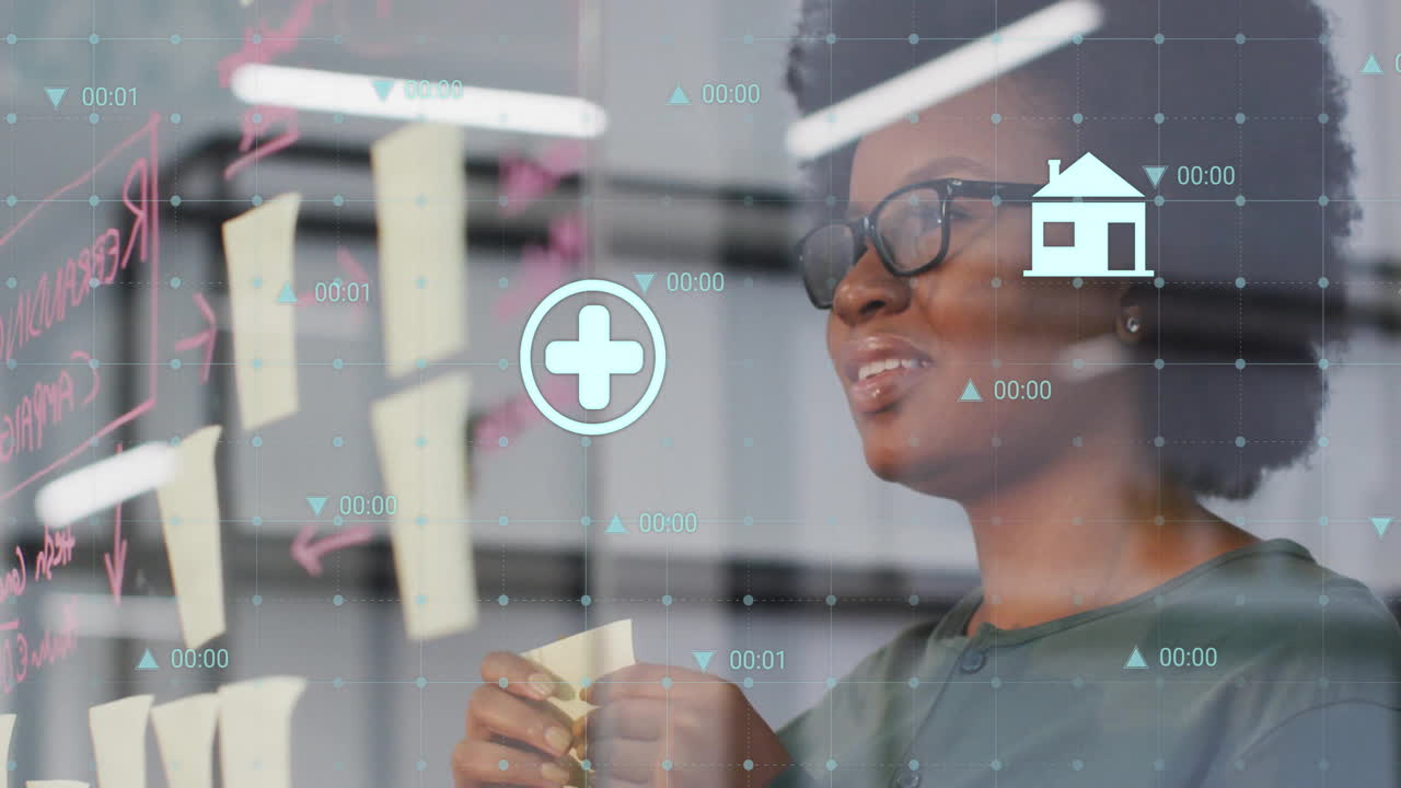 Animation of data processing over biracial casual businesswoman taking notes on glass wall