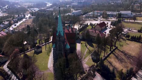 Aerial-shot-of-huge-old-church-located-in-the-small-town