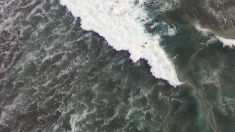 a surfer riding the waves of bali, indonesia - slow motion