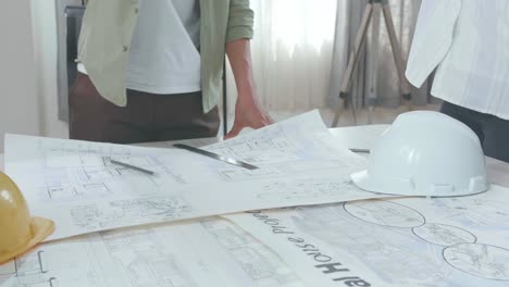 close up of group of asian engineers create harmony with hands on top of each other at the office