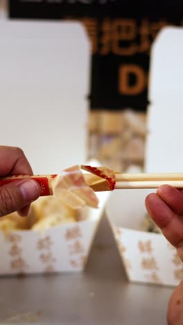 hands preparing chopsticks for a meal