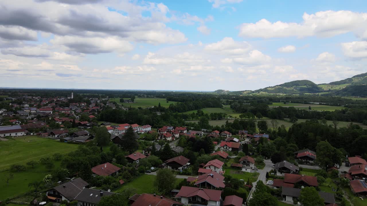 The drone flies over the Bavarian village in the Alps. German mountain landscape in Upper Bavariadrone