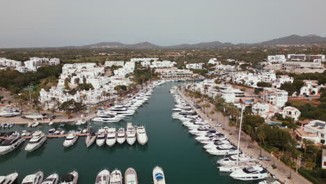 mediterranean marina with yachts and white buildings