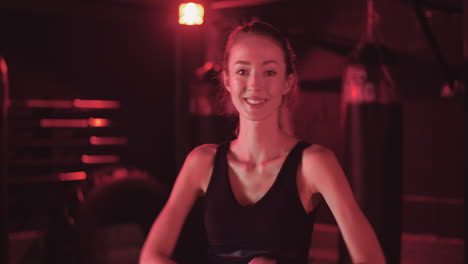 Handheld-Shot-Of-Confident-Young-Woman-Standing-With-Arms-Crossed-At-Health-Studio