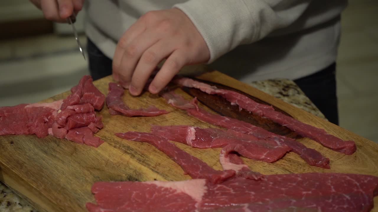 Slicing Steak on a Cutting Board in Slow Motion.