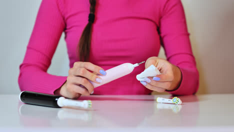 Electric toothbrush cleaned, maintained with hygiene care by woman, slow motion