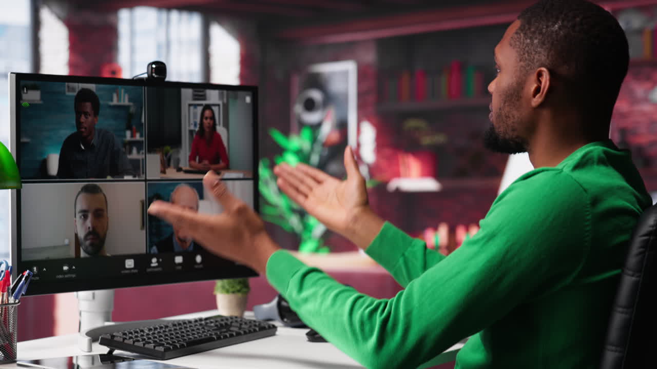 Vertical Video Remote worker looking at PC monitor discussing with coworkers