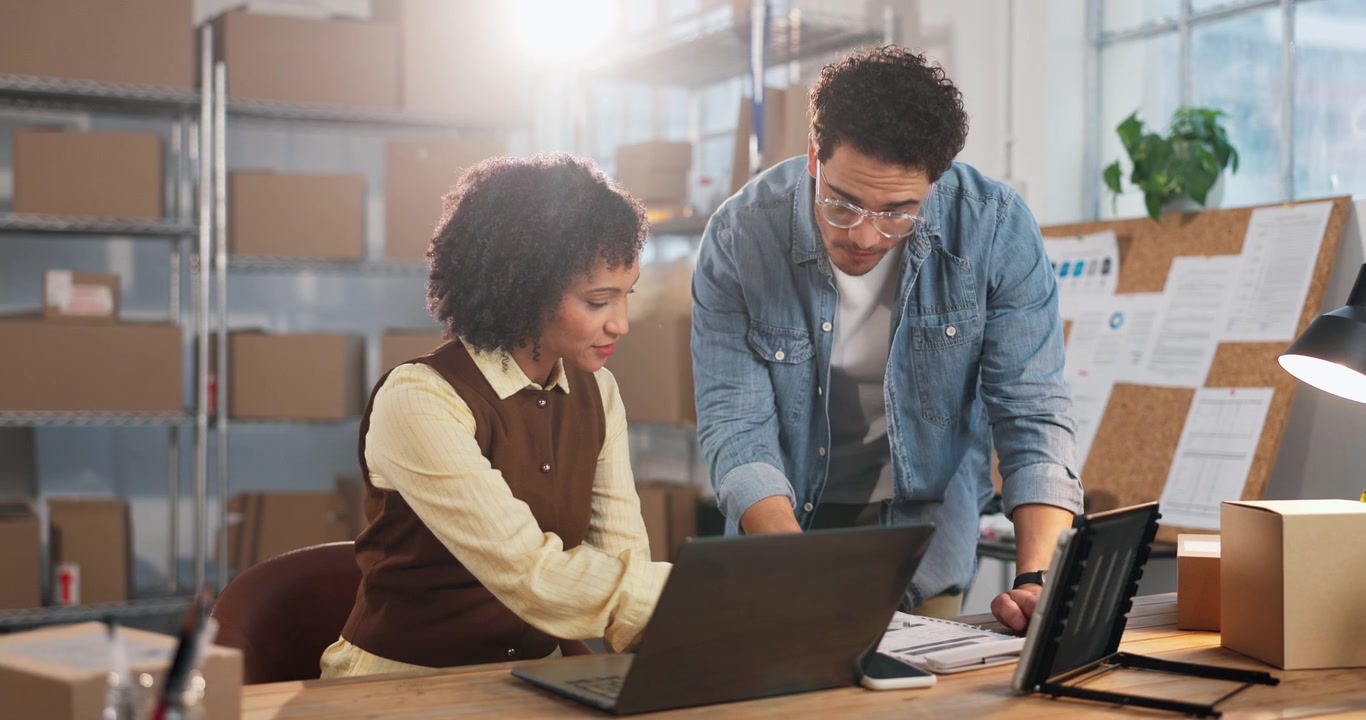 Two Colleagues Collaborating on a Project in a Warehouse Office