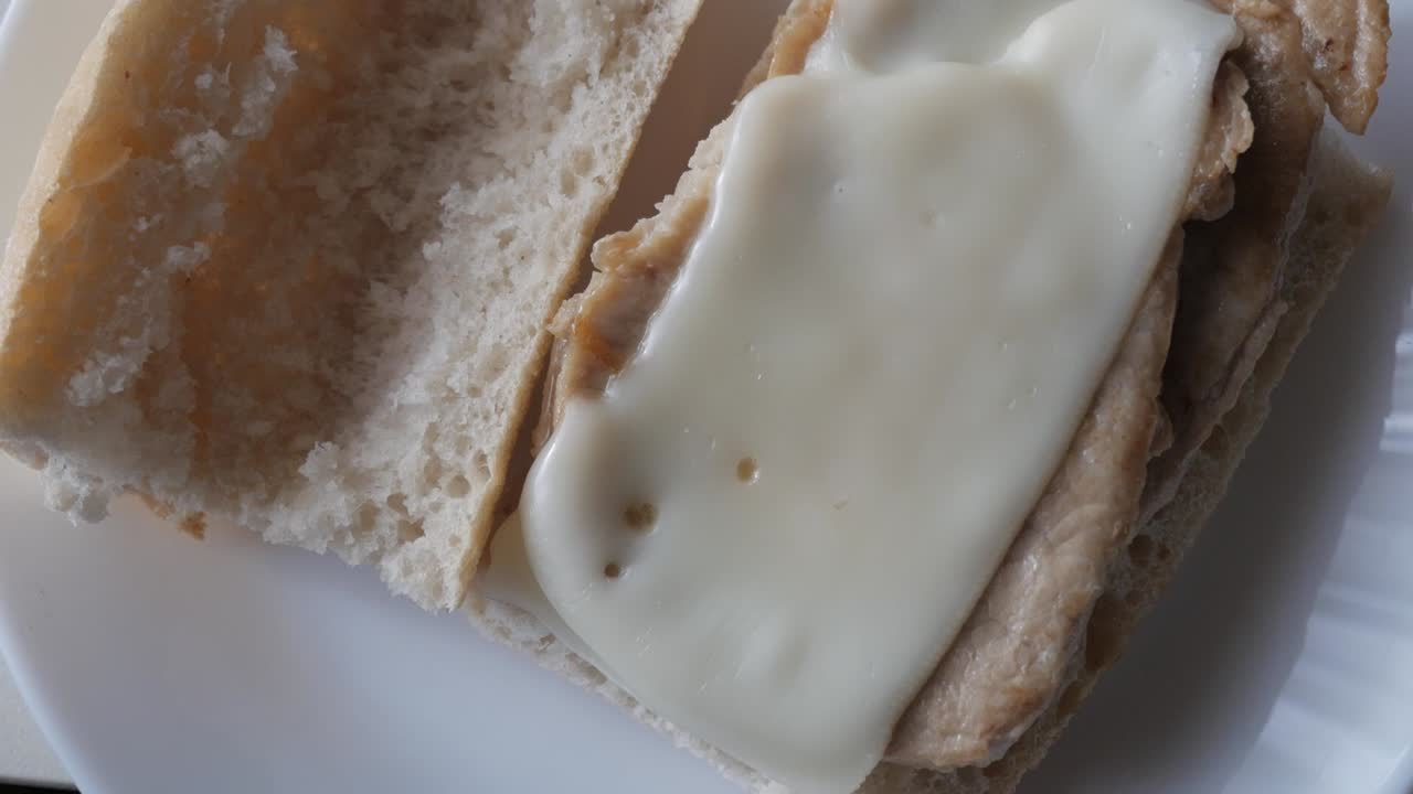 Bocadillo pork tenderloin sandwich with melted cheese on soft bread