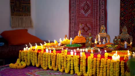 indian religious ceremony with candles and marigolds