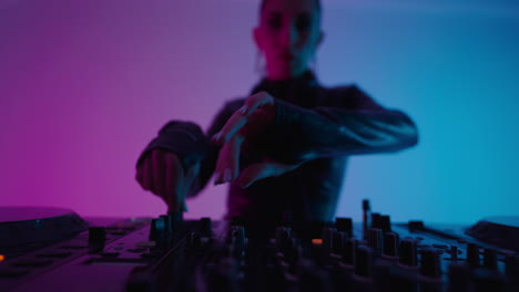 woman dj mixing music on turntables