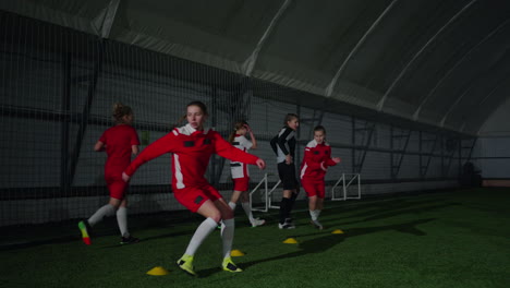 young women soccer players practicing indoor