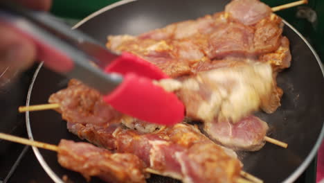 frying delicious souvlaki skewers over a hot skillet